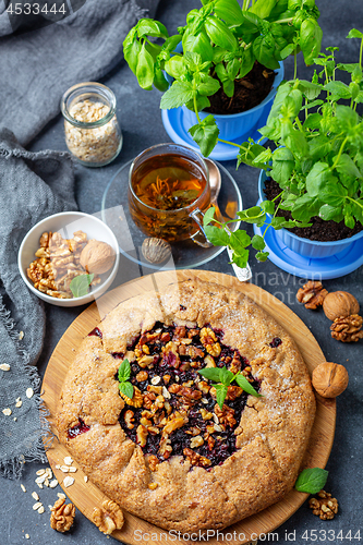 Image of Homemade currant pie and a cup of green tea.