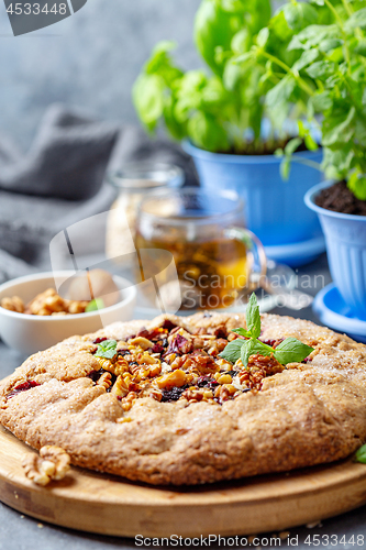 Image of Homemade galette pie with currants and walnuts.