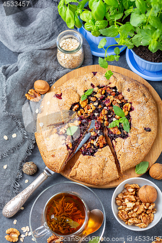 Image of Green tea and Galette pie with black currants.