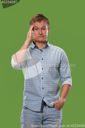 Image of Young serious thoughtful businessman. Doubt concept.