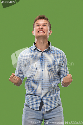 Image of Winning success man happy ecstatic celebrating being a winner. Dynamic energetic image of male model