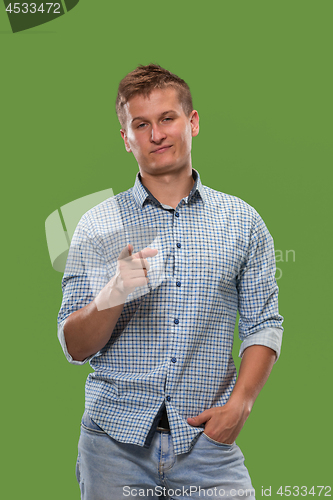 Image of The overbearing businessman point you and want you, half length closeup portrait on green background.