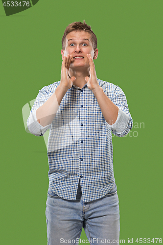 Image of Isolated on green young casual man shouting at studio