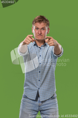 Image of The overbearing businessman point you and want you, half length closeup portrait on green background.