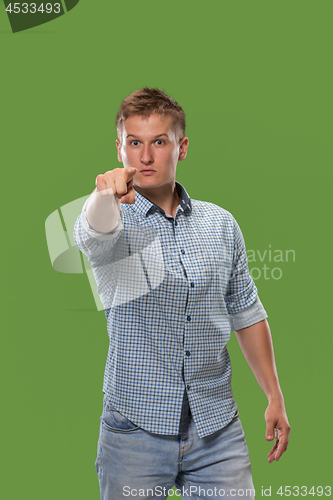 Image of The overbearing businessman point you and want you, half length closeup portrait on green background.