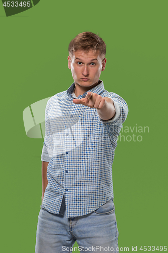 Image of The overbearing businessman point you and want you, half length closeup portrait on green background.