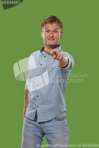 Image of The happy business man point you and want you, half length closeup portrait on green background.