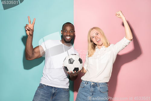 Image of The young fans celebrating on blue and pink trendy colors.