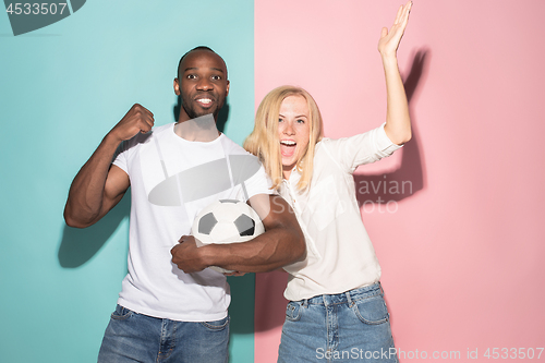 Image of The young fans celebrating on blue and pink trendy colors.