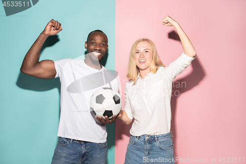 Image of The young fans celebrating on blue and pink trendy colors.