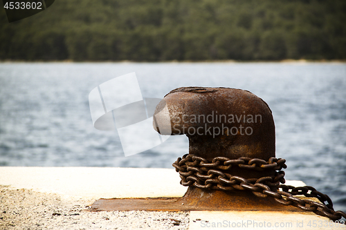 Image of Old and rusty mooring post