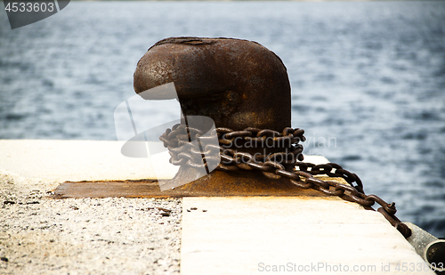 Image of Old and rusty mooring post