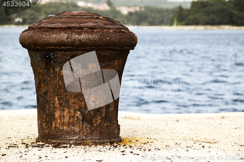 Image of Old and rusty mooring post