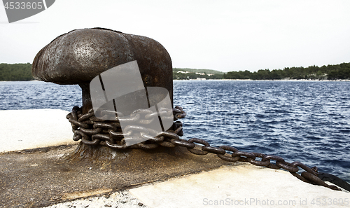 Image of Old and rusty mooring post