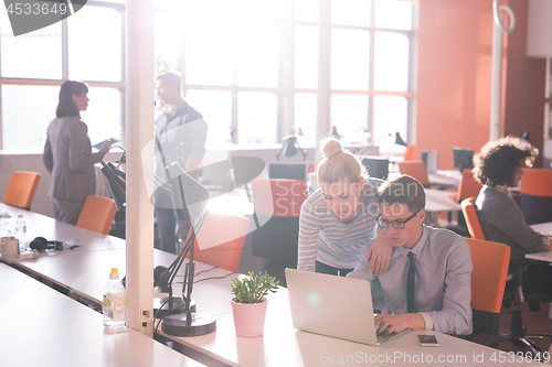 Image of Two Business People Working With laptop in office