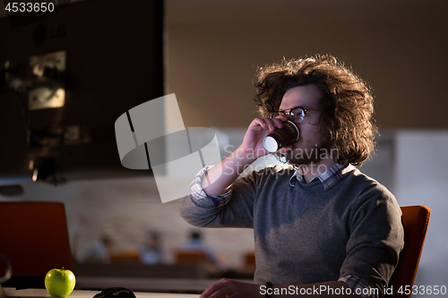 Image of Tired businessman working late