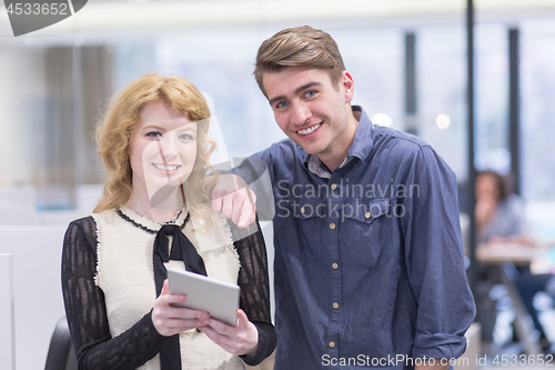 Image of Business People Working With Tablet in startup office