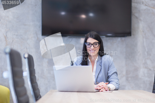 Image of businesswoman using a laptop in startup office