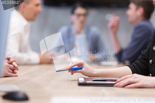 Image of businesswoman hand using pen