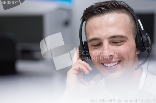 Image of male call centre operator doing his job