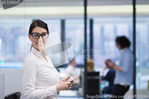 Image of Elegant Woman Using Mobile Phone in startup office building