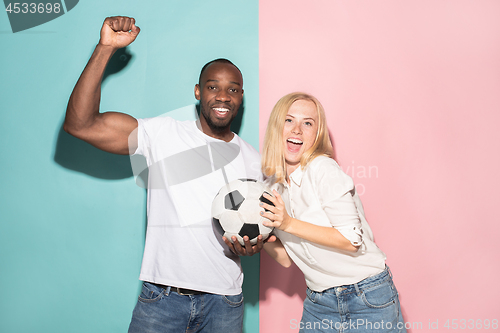 Image of The young fans celebrating on blue and pink trendy colors.