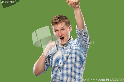 Image of Winning success man happy ecstatic celebrating being a winner. Dynamic energetic image of male model