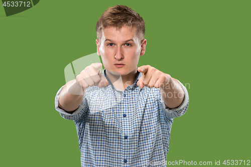 Image of The overbearing businessman point you and want you, half length closeup portrait on green background.