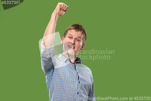 Image of Winning success man happy ecstatic celebrating being a winner. Dynamic energetic image of male model