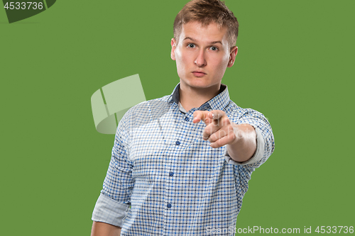 Image of The overbearing businessman point you and want you, half length closeup portrait on green background.