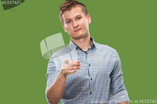 Image of The overbearing businessman point you and want you, half length closeup portrait on green background.