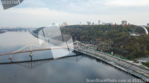 Image of Aerial view of Bridge pedestrian across the Dnieper River, Embankment with traffic and the People\'s Friendship Arch on the mountain