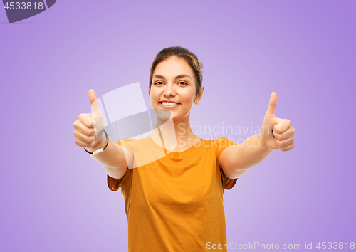 Image of teenage girl in t-shirt showing thumbs up