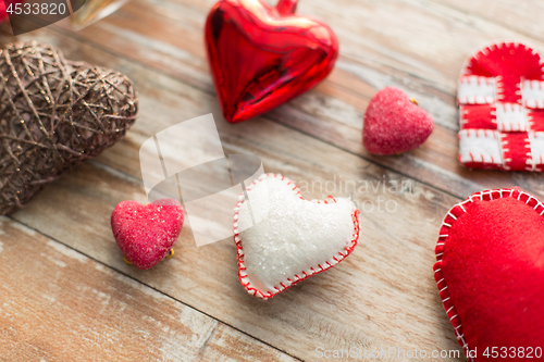 Image of heart shaped decorations on wooden background