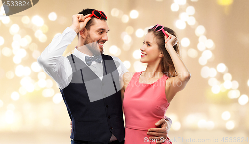 Image of happy couple in heart-shaped sunglasses