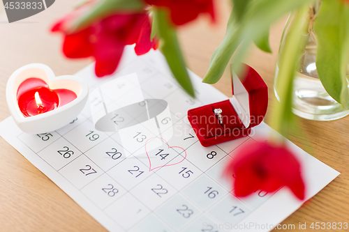 Image of diamond ring and calendar sheet on valentines day