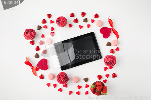 Image of tablet pc and sweets on valentines day