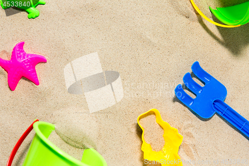 Image of close up of sand toys kit on summer beach