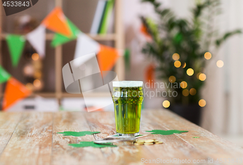 Image of glass of green beer, horseshoe and golden coins
