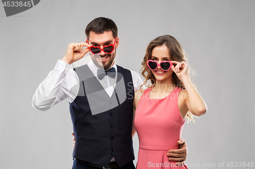 Image of happy couple in heart-shaped sunglasses