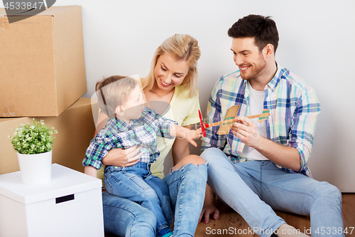 Image of happy family with boxes moving to new home