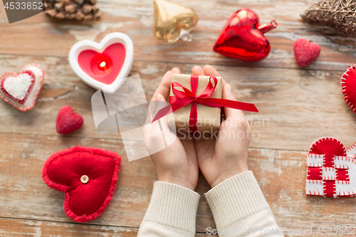 Image of hands holding christmas or valentines day gift