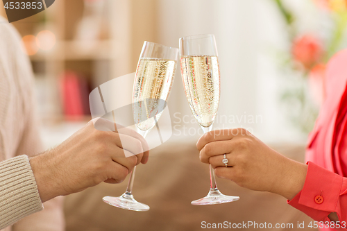 Image of close up of couple clinking champagne glasses