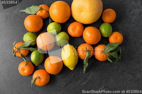 Image of close up of citrus fruits on stone table