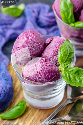 Image of Blueberry ice cream with basil in glasses.