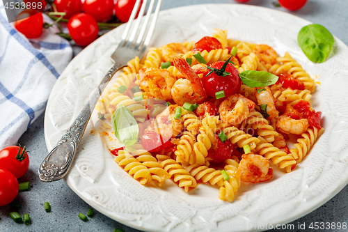 Image of Pasta with shrimp in tomato sauce close up.