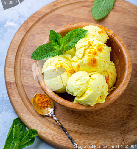 Image of Golden ice cream with turmeric closeup.