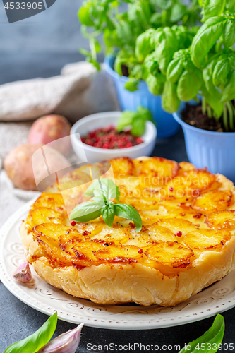 Image of Traditional Tarte Tatin with potatoes and garlic.