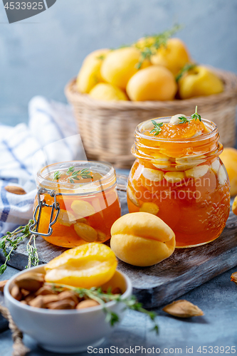 Image of Homemade apricot jam with thyme and sweet almonds.