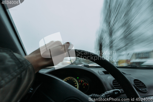 Image of Riding behind the wheel of a car in winter